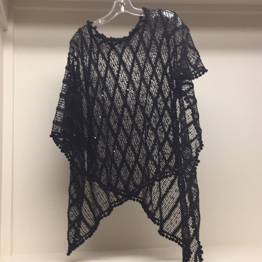 Fun poncho adorned with small PomPoms and sequins